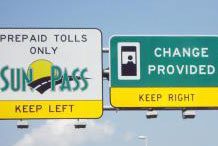 A highway sign with a sign that says prepare tolls only provided.