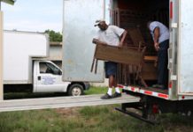 Two men loading a moving truck.