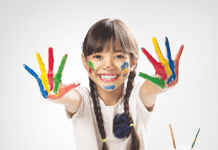 A girl with paint on her hands.
