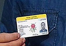 A man holding up an id card with a flower on it.