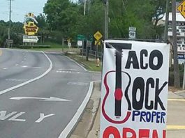 Sign reads: Taco Rock Proper Open Soon