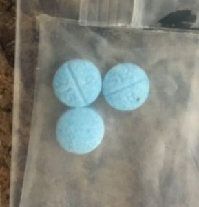 blue pills in blastic bag.