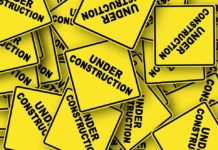 yellow caution signs that say "under construction"