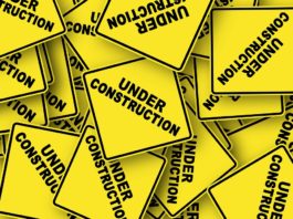 yellow caution signs that say "under construction"