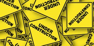 yellow caution signs that say "under construction"
