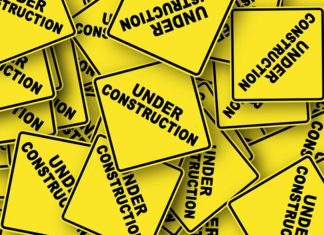 yellow caution signs that say "under construction"