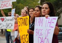 women holding signs supporting DACA