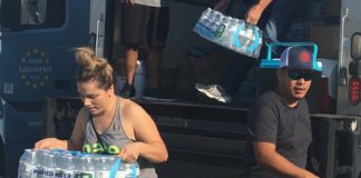 volunteers load truck with bottled water