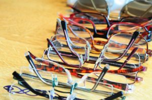 Row of multiple eye glasses on a table