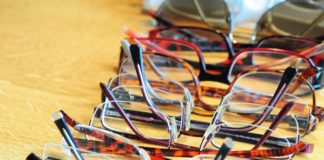 Row of multiple eye glasses on a table