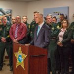 Florida Governor Scott standing with county sheriffs