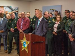Florida Governor Scott standing with county sheriffs
