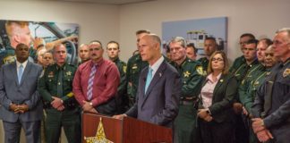 Florida Governor Scott standing with county sheriffs