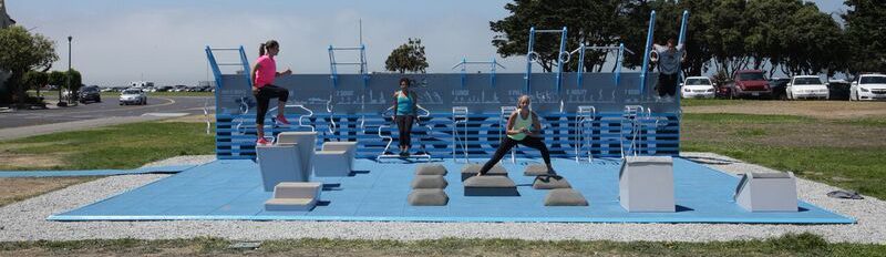 Outdoor gym equipment with people exercising