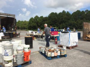 pallets of collected paint and chemical containers