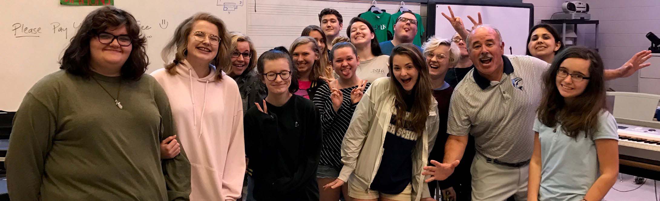 High school students cheering with their principle