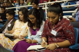 three women writing notes