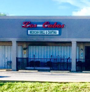 store front of los cabos restaurant with metal covers over windows