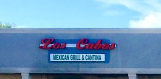 store front of los cabos restaurant with metal covers over windows
