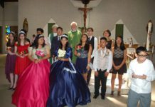 teens and preists standing in front of altar