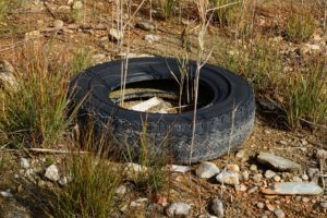 old tire in dirt and rocks