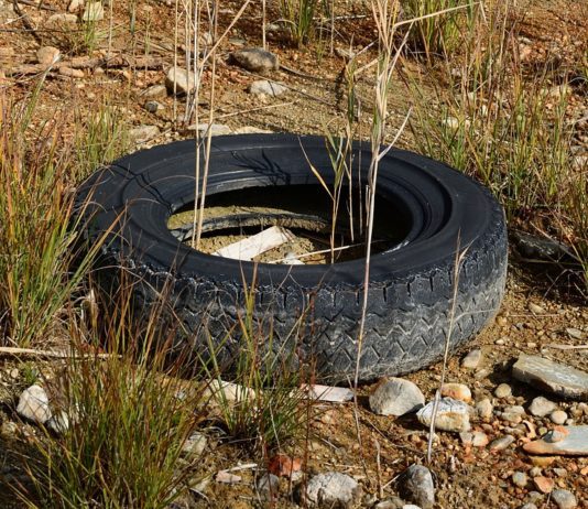 old tire in dirt and rocks