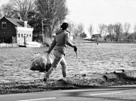 woman picking up litter in cold weather