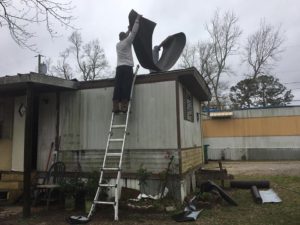 two men repairing roof