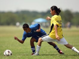 two boys playing soccer
