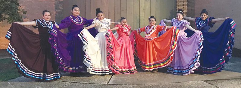 Jalisco dancers with colorful dresses extended