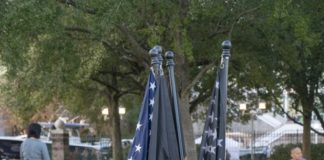 American and Police flag standing in park