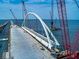 Construction of a bridge over a body of water.