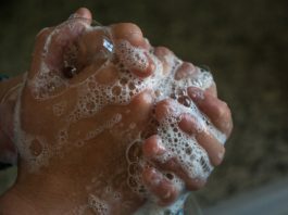 A person is washing their hands with soap.