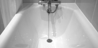 A black and white photo of a bathtub.