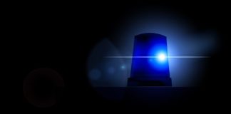 A blue police light on a dark background.