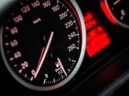 A close up of a speedometer in a car.