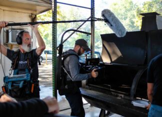 Camera crew recording meat on a grill