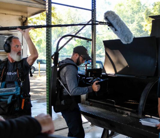 Camera crew recording meat on a grill