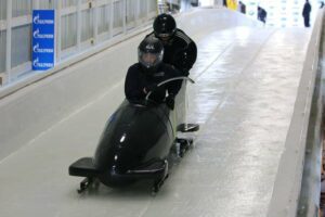 two people racing on a bobsled