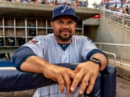 baseball player standing in a dugout