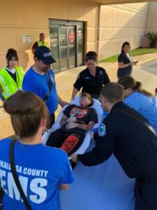 people surrounding a wounded patient