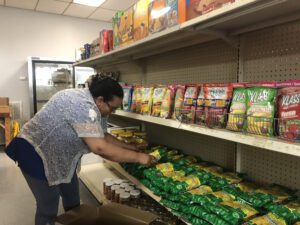 person stocking store shelf