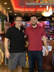 two men standing in a restaurant