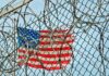 US flag behind fence