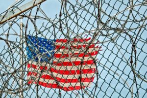 US flag behind fence