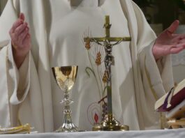 priest offering mass