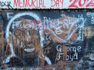 defaced mural of George Floyd