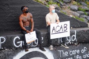 two protesters holding signs