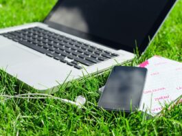 laptop and smart phone on grass