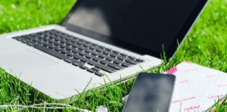 laptop and smart phone on grass